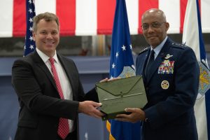Rob Collings, American Heritage Museum's President, and U.S. Air Force Chief of Staff Gen. CQ Brown, Jr., exchange a map signed by the Tuskegee Airmen during the PT-17 Stearman Aircraft Exchange ceremony at Joint Base Andrews, Md., July 26, 2023. Brown became an honorary Tuskegee Airman in August 2021. (U.S. Air Force photo by Senior Airman Tyrone Thomas)