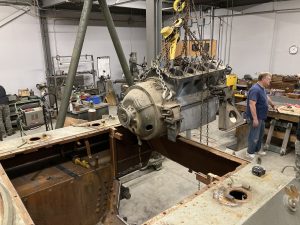 The test core Ford GAA engine for the reconstruction of the engine compartment goes in for a test fit.